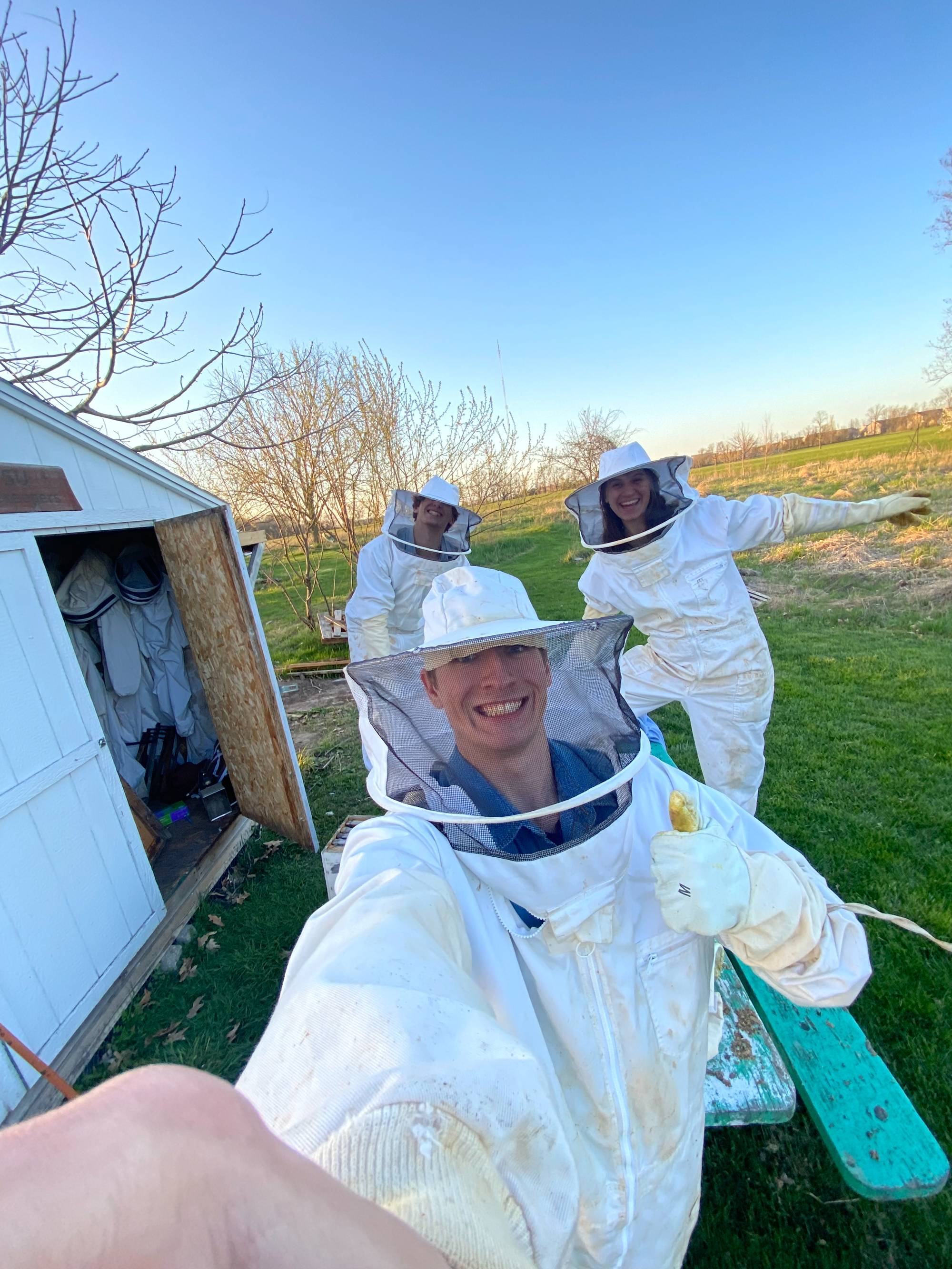 Three students in bee keeping outfits